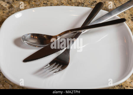 empty square white plate with fork, knife and spoon Stock Photo