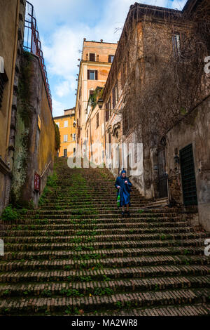 A nun on Via di Sant'Onofrio which becomes a steep stairway giving a shortcut up to  Janiculum Hill in Trastevere for views of Rome. Lazio. Italy. Stock Photo