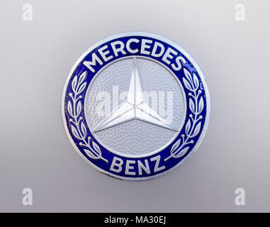 Mercedes-Benz three pointed star car badge and logo or hood-ornament. Stock Photo