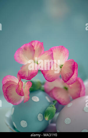 Pink flowers on colored eggs Stock Photo