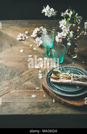 Spring Easter holiday Table setting over vintage wooden background Stock Photo