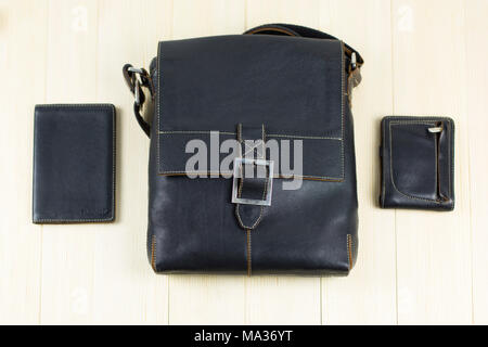A set of men's leather accessories, a bag, a passport cover, a wallet, a handbag, a keychain case on a light background Stock Photo