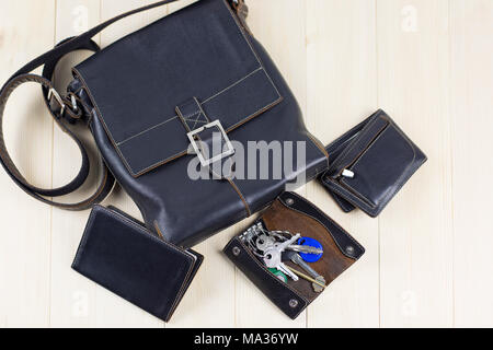 A set of men's leather accessories, a bag, a passport cover, a wallet, a handbag, a keychain case on a light background Stock Photo
