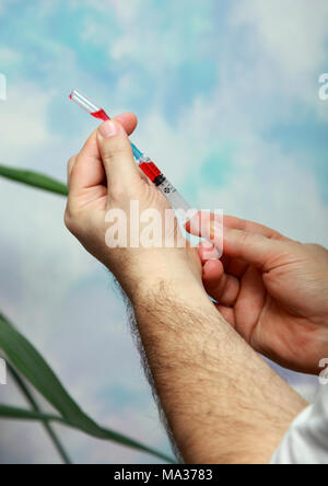 People gaining in a syringe medication red. Stock Photo