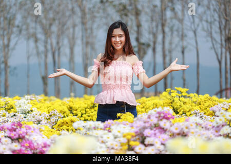 beautiful woman in colorful chrysanthemum glower garden Stock Photo