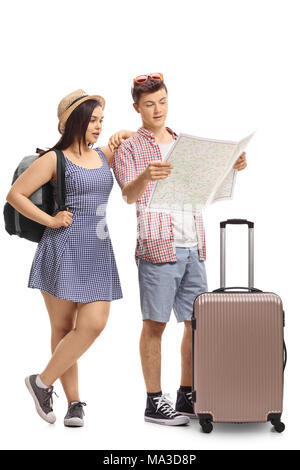 Full length portrait of teenage tourists looking at a map isolated on white background Stock Photo