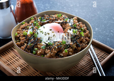 Japanese ground beef bowl with steamed egg on top and ingredient. Stock Photo
