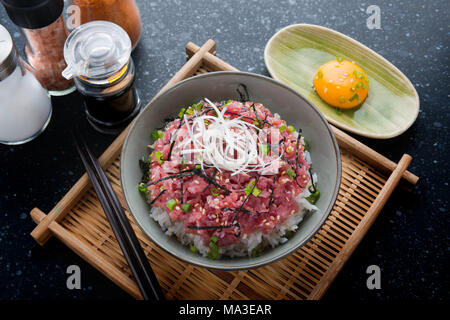 Ground raw tuna and onion with rice in Japanese style call nekitoro don set in bowl ready to serve. Stock Photo