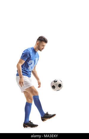 Full length profile shot of a soccer player with a football isolated on white background Stock Photo