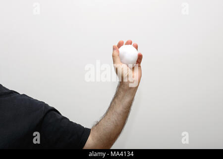 Man Holding Snowball in Hairy Hand Stock Photo