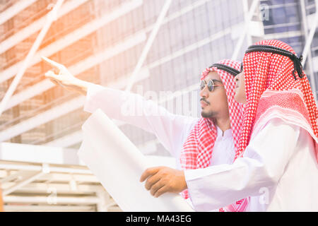 Arab business people in a meeting, business people standing in the construction site discussing work Stock Photo