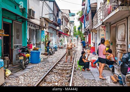 Bustling activity on the train tracks in Hanoi, Vietnam Stock Photo