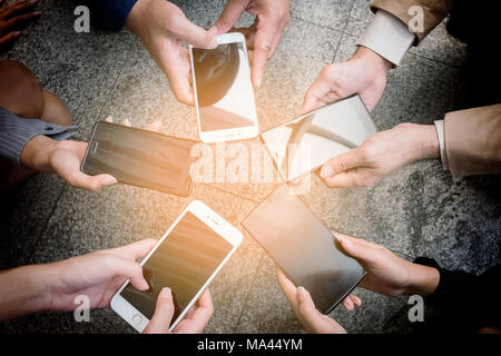 Business team working together,meeting and using mobile smart phone.Concept of business, technology, social media Stock Photo