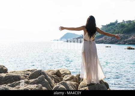 Young woman stretching in the morning sun Stock Photo