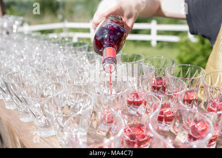 Hands of a waiter that makes out pyramid from glasses for drinks, wine, champagne, festive mood, celebration Stock Photo