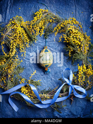 Easter empty background with Easter eggs and spring flowers. Top view with copy space. Stock Photo