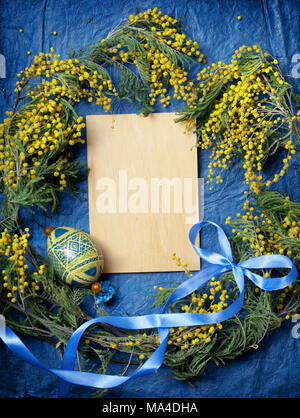 Easter empty background with Easter eggs and spring flowers. Top view with copy space. Stock Photo