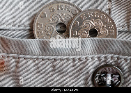 Denmark coins denomination is five and two krone (crown) in the pocket of beige denim jeans with button Stock Photo