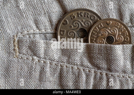 Denmark coin denomination is two and five krone (crown) in the pocket of worn linen pants Stock Photo