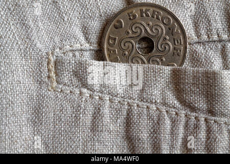 Denmark coin denomination is five krone (crown) in the pocket of worn linen pants Stock Photo