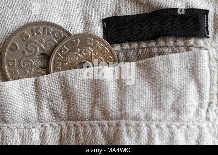 Denmark coin denomination is two and five krone (crown) in the pocket of old linen pants with black stripe Stock Photo