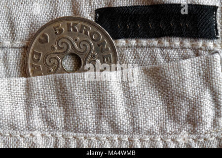 Denmark coin denomination is five krone (crown) in the pocket of old linen pants with black stripe Stock Photo