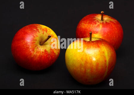Three red ripe apples isolated on a black background Stock Photo
