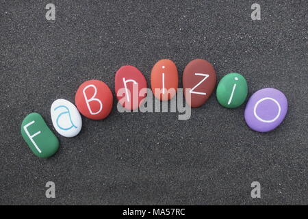 Fabrizio, masculine given name with multicolored stones over black volcanic sand Stock Photo