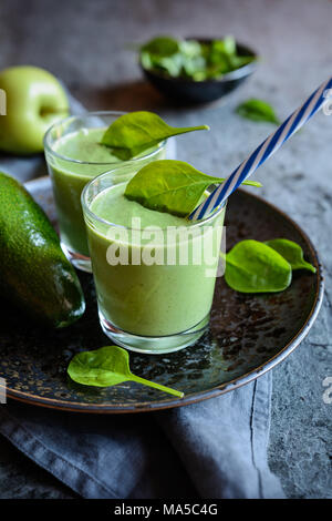 Healthy avocado, spinach and apple smoothie in glass jars Stock Photo