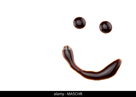 smile made from chocolate syrup, isolated on white. Stock Photo