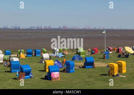 Grünstrand Burhave, Butjadingen, in the background container terminal of Bremerhaven, municipality in the administrative district of Wesermarsch, Stock Photo