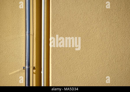 Close-up of newly installed stainless steel rain pipes on a new facade, Stock Photo