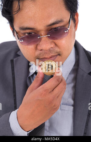 man holding golden bitcoin in hand isolated on a white background Stock Photo