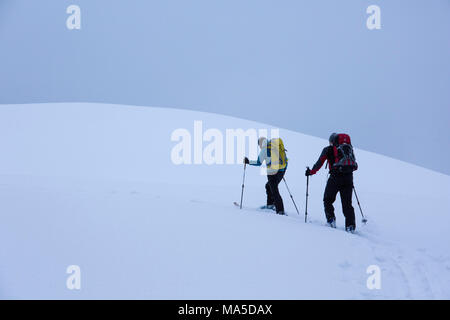 ski tourers while climbing the Lenggrieser Hütte (hut) in winter, Lenggries, Bavarian Prealps, Bavaria, Germany Stock Photo