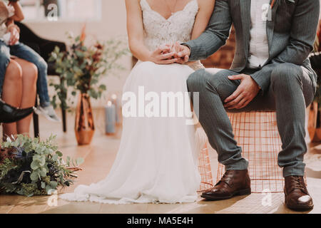 Bridal couple, sitting, holding hands, detail, Stock Photo