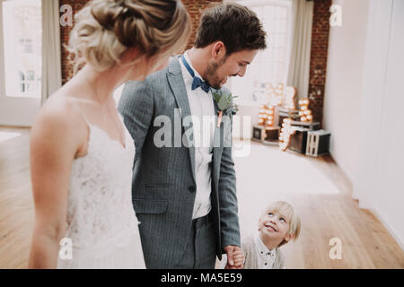 Bridal couple and boy holding hands, happy, Stock Photo