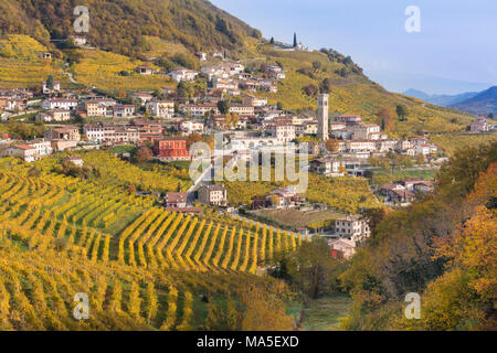 the village of Santo Stefano surrounded by the yellow vineyards in autumn, along the road of wine, Valdobbiadene, Treviso, Veneto, Italy Stock Photo