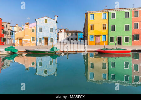 colorful houses in Burano reflected in the water canal, Venice, Veneto, Italy Stock Photo