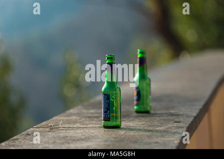 Two empty green beer bottles abandoned on top of a wall on Janiculum hill, Rome, Italy. Stock Photo