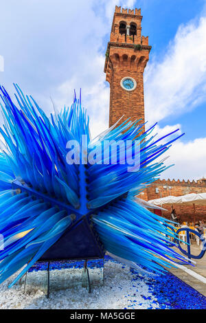 Glass sculpture under the bell tower of Murano, Venice, Veneto, Italy. Stock Photo