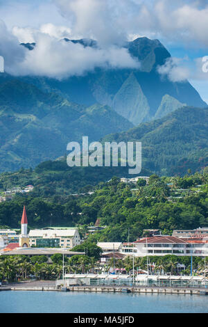Dramatic mountains looming behind Papeete, Tahiti, French Polynesia Stock Photo