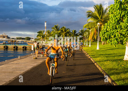 Local boys on their bicycles, Waterfront of Papeete, Tahiti, French Polynesia Stock Photo
