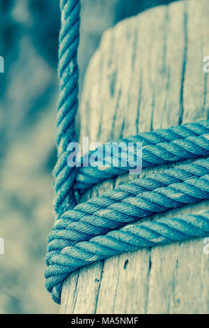 Pole with a rope tied around it, vintage style Stock Photo