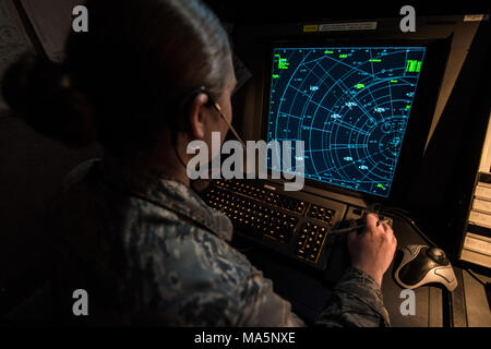 An air traffic controller trains on a simulator in the Radar Approach Control(RAPCON) facility March 22, 2018, at Vance Air Force Base, Okla. The simulator trains Airmen for day to day air traffic scenarios. (U.S. Air Force photo by Airman Zachary Heal) Stock Photo