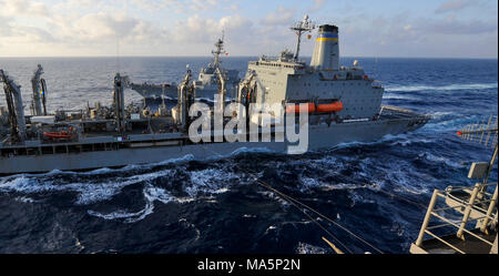 180329-N-VK310-0003 PHILIPPINE SEA (March 29, 2018) The amphibious assault ship USS Wasp (LHD 1) conducts a replenishment-at-sea with the fleet replenishment oiler USNS Tippecanoe (T-AO 199) and the Arleigh Burke-class guided missile destroyer USS Dewey (DDG 105). Wasp, part of the Wasp Expeditionary Strike Group, with embarked 31st Marine Expeditionary Unit, is operating in the Indo-Pacific region to enhance interoperability with partners, serve as a ready-response force for any type of contingency and advance the Up-Gunned ESG concept. (U.S. Navy photo by Mass Communication Specialist 3rd Cl Stock Photo