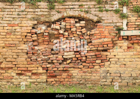Bad repair of broken brick wall Stock Photo