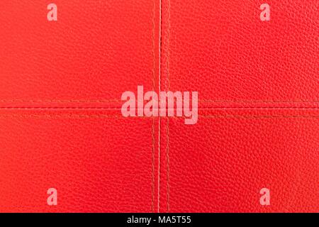 Red leather with stitch texture and plus symbol Stock Photo