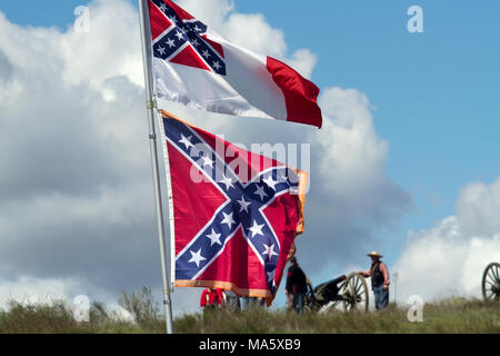 Confederate flags flying against a blue sky and clouds Stock Photo