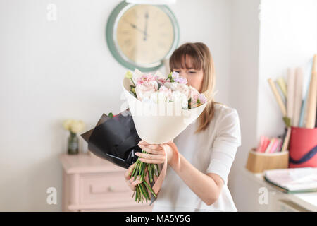 beautiful luxury bouquet of mixed flowers in woman hand. the work of the florist at a flower shop. A small family business Stock Photo