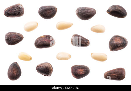 Unshelled pine nuts and shelled nuts on white background. Macro. Stock Photo